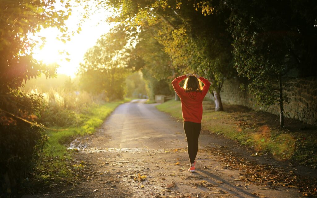 Woman walking outdoors to support liver health and weight loss