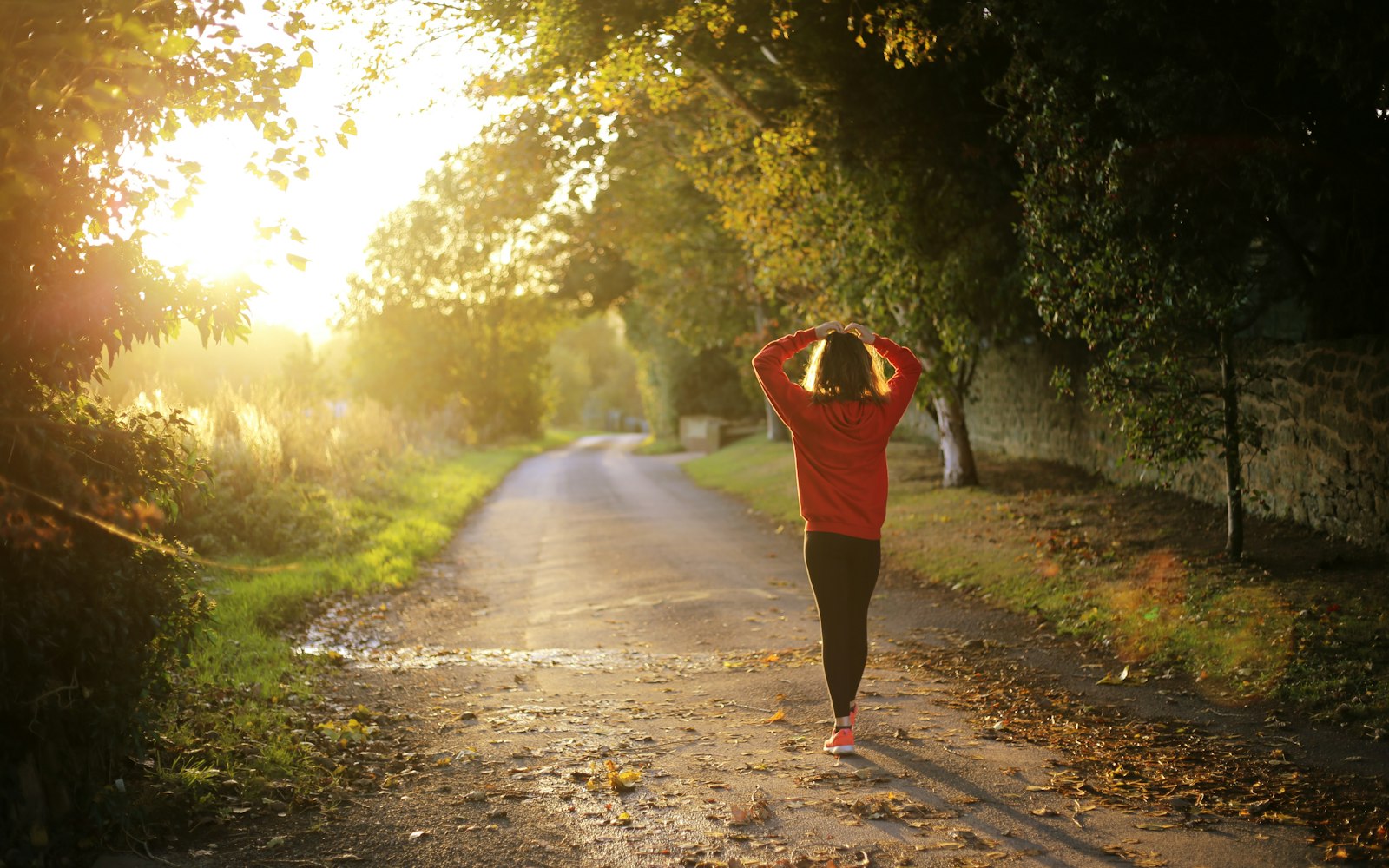 Woman walking outdoors to support liver health and weight loss